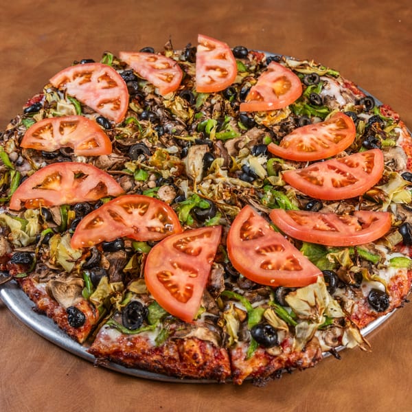 Mark & Monica's Family Pizza with tomatoes, olives, green peppers, mushrooms, and artichoke hearts.